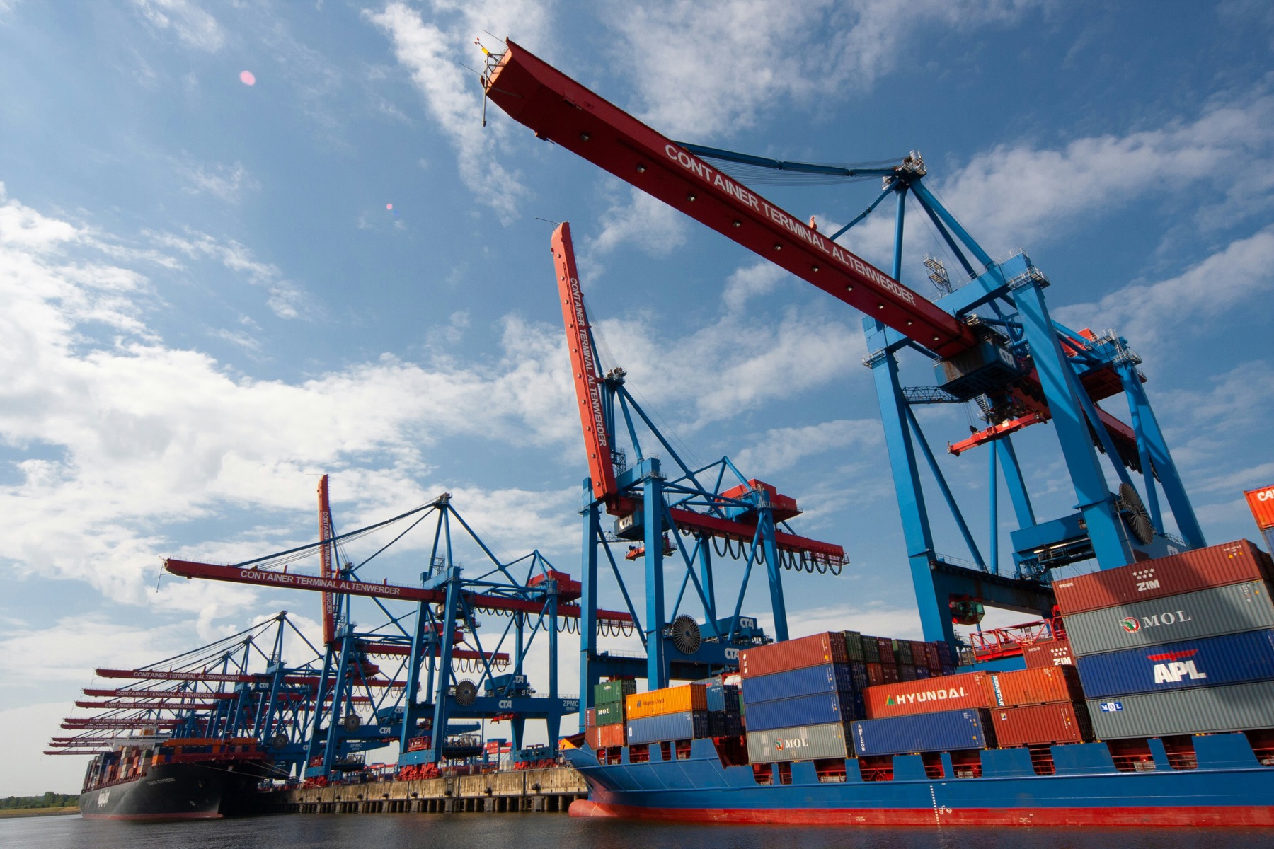 Port cranes and container handling area for international shipment coordination